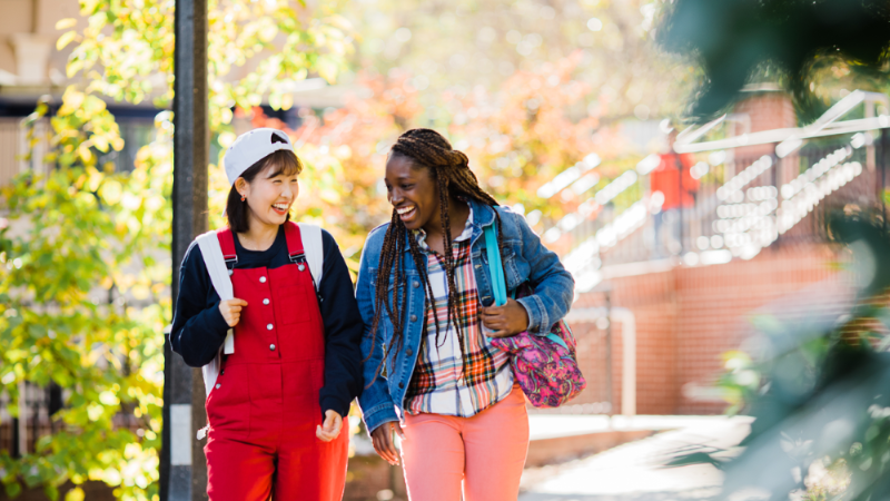 Two students walking on campus